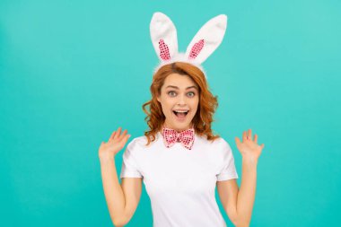 Tavşan kulaklı ve mavi arka planda papyonlu Paskalya kadını.