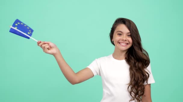 Amazed child waving european union flag on blue background showing thumb up, eurozone — Stock Video