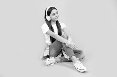 Okula dönüyorum. Okul gerçekten eğlenceli. Kulaklıklı mutlu genç kız. müzik dinle..