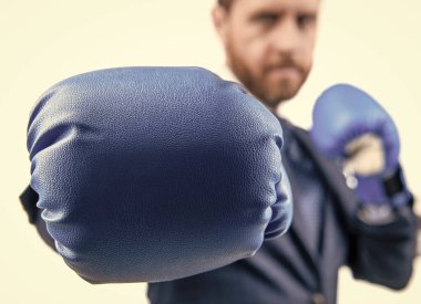 Professional man in formal suit stand in fighting position wearing boxing glove selective focus clipart