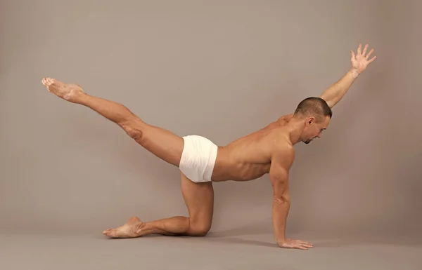 Yoga per equilibrio e stabilità. Il tipo in forma fa la posa da tavolo di bilanciamento. Equilibrio allenamento e allenamento — Foto Stock