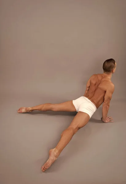 Athletic man do cobra pose. Gymnastic routine. Back bending asana in hatha yoga. Gymnastic activity