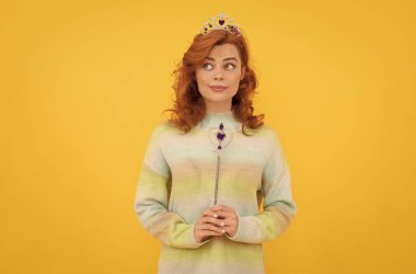 Kraliçe tacındaki kızıl saçlı kadın sihirli değnekle, dile.