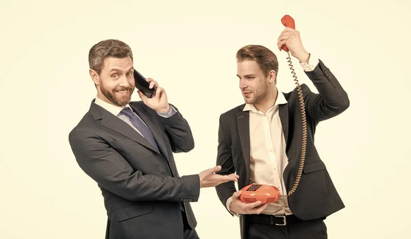 stock image Employer with smartphone laugh at employee using retro telephone isolated on white, communication