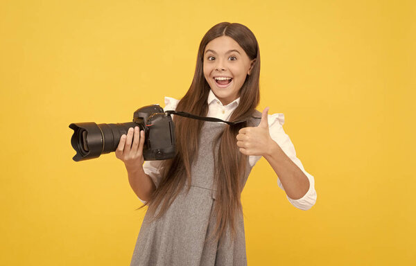 happy teen girl photographer use digital photo camera show thumb up, photographing