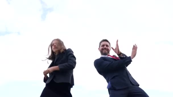 Gelukkig zakenstel zakenman en zakenvrouw doen jas uit dansen in de lucht, vrijheid — Stockvideo