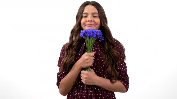 Portrait de beauté d'enfant cheveux bouclés tenir bouquet de fleurs sauvages odeur centaurée, odeur de printemps. — Video