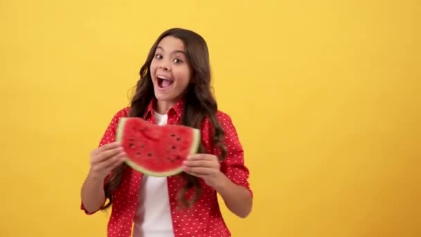 Happy child turning with water melon slice on yellow background, vitamin — Stock Video