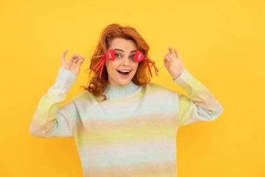 Kırmızı kalpli komik kızıl kızın sarı arka plana yapışmasına sevindim. 14 Şubat