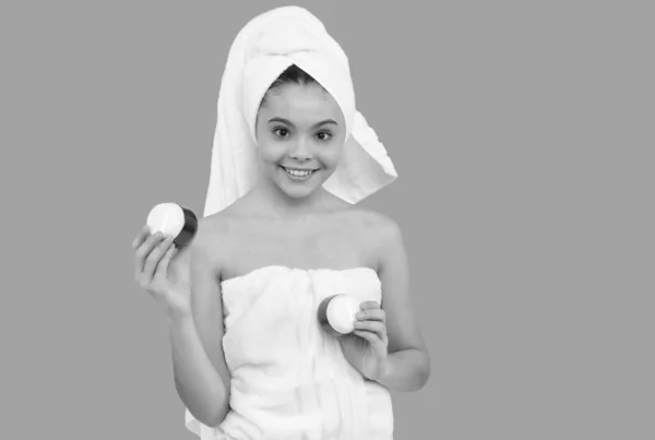 Reinigen schrobben. presentatie cosmetische product voor tiener. Het kind gebruikt gezichtscrème. gelukkig meisje — Stockfoto