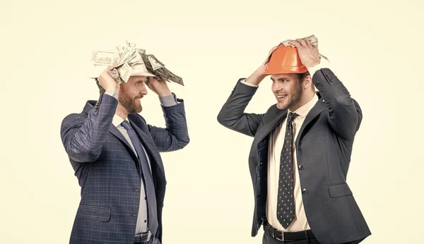 financial support. investment in architectural project. two men businessman in hardhat with money.