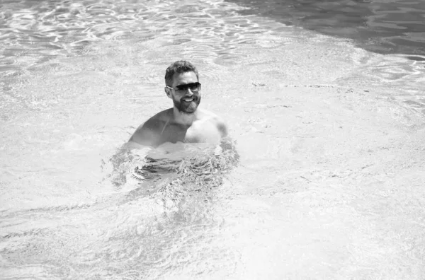 Szczęśliwy brodaty mężczyzna w okularach słonecznych zrelaksować się w spa basen na letnie wakacje, lato. — Zdjęcie stockowe