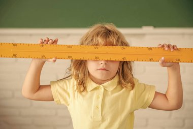 Okuldaki çocuk elinde matematik cetveli, okul...