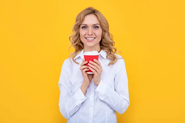 Positive blonde woman with morning coffee cup on yellow background —  Fotos de Stock
