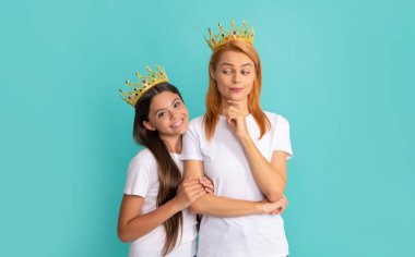 I got it from my mother. Selfish mother smile at daughter. Happy woman and girl child in crowns clipart