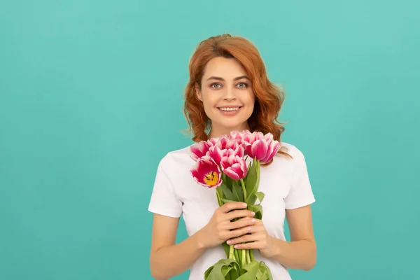 Happy girl with tulip flower bouquet on blue background. 8 march — Stok fotoğraf