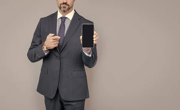 Confident businessman man in suit demonstrating mobile phone, copy space, modern gadget. — Stock Photo, Image