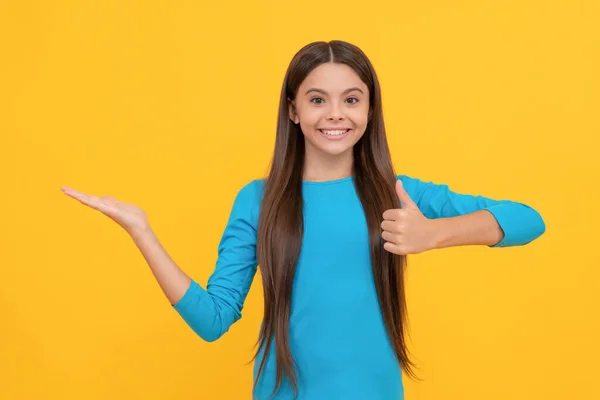 Happy pretty look of young girl. face portrait of child on yellow background. — ストック写真