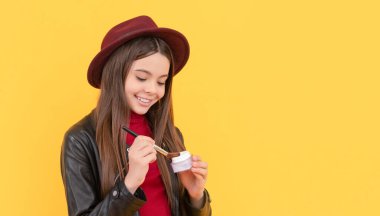 cheerful child apply face powder. teen girl hold blush. kid with makeup brush.