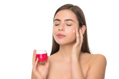 young woman applying cream for face skin with hand isolated on white background, personal care