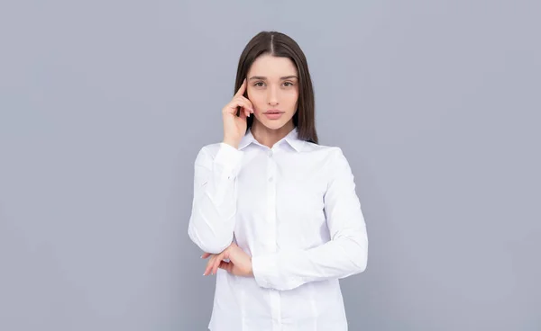 Thinking businesslady in white shirt on grey background, ceo — Stok fotoğraf