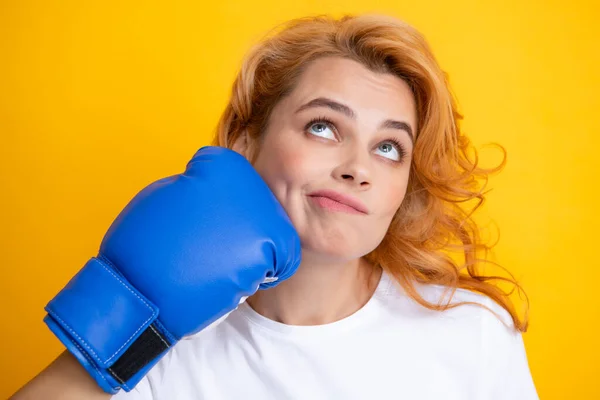 Close up portrait of funny woman with boxing gloves with punching face isolated on yellow background Woman in boxing gloves. — Stockfoto