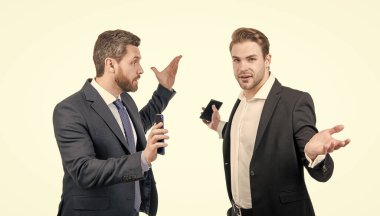 İş adamları konuşuyor ve anlaşmazlıkları tartışıyor. Patron ve çalışanın akıllı telefonu var..