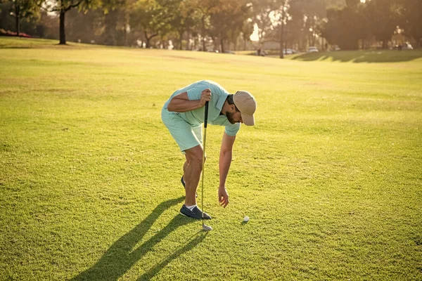 Man playing game on green grass taking ball. summer activity. professional sport outdoor — Stock Photo, Image