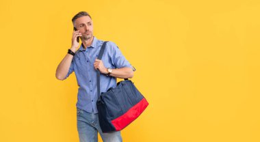 man has conversation hold sports bag. phone call negotiation.