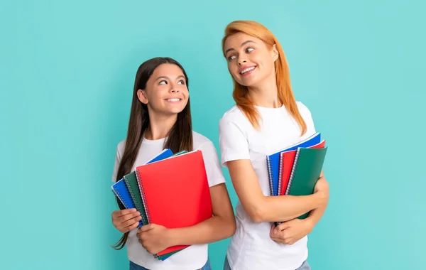 Cheerful school pupil and student holding notebooks, back to school — Stockfoto