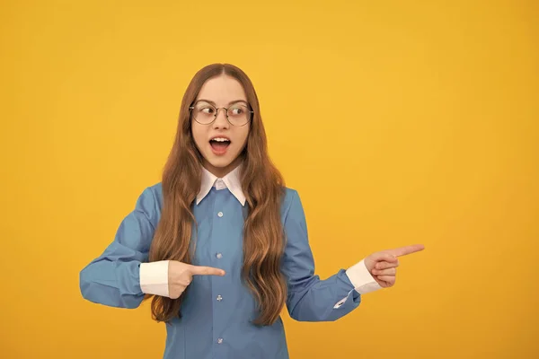 Surprised kid point fingers yellow background. Pointing for advertising. Pointing gesture, copy space — Fotografia de Stock