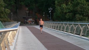 muscular young sportsman jogging outdoor for training, stamina