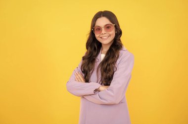 beautiful happy teen girl with curly hair in stylish purple jacket and sunglasses, fashion model.