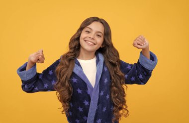 Keyfim yerinde. Uykulu çocuk uykusunda geriniyor. Rahat pijama giyen gülümseyen çocuk.