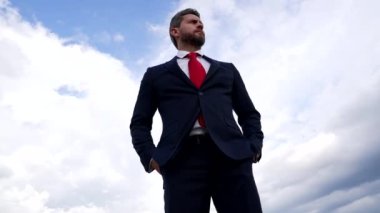 serious bearded man in business suit on sky background, business fashion