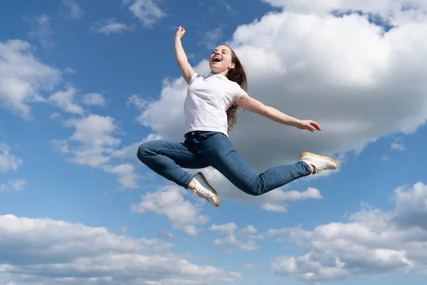 Happy teen child jump on sky background — стоковое фото