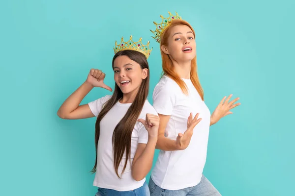 Advertising your prom. Selfish woman and girl point fingers at white tshirts. Tshirt advertising, copy space — Fotografia de Stock