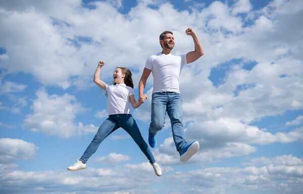 happy father and daughter jump in sky. imagination