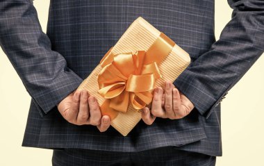 kırpılmış işadamı hediye kutusunu saklıyor, arkadan bakıyor, sürpriz