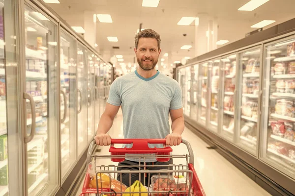 customer with shopping cart buying food at grocery, supermarket