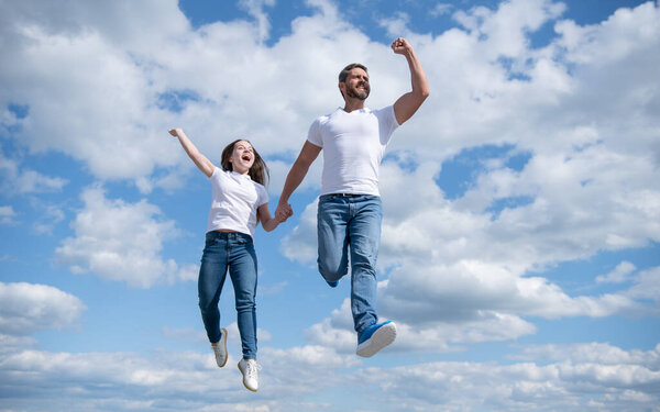 happy father and daughter jump in sky. bright future