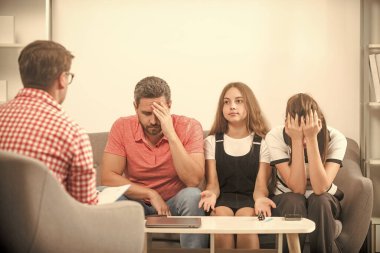 Aile terapisi. Çocuklu aileler sosyal hizmetlilerle konuşur. Anne, baba ve kızı..