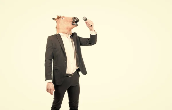 Professional man wear horse head mask in formalwear singing karaoke song, costume party — 图库照片