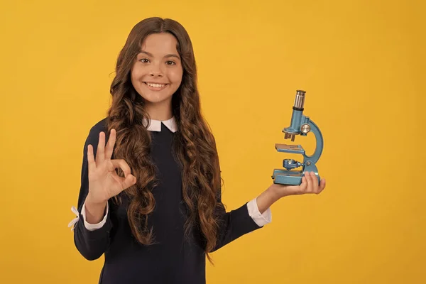 Ciencia e infancia. adolescente chica presentando microscopio. de vuelta a la escuela. biología de estudio, — Foto de Stock