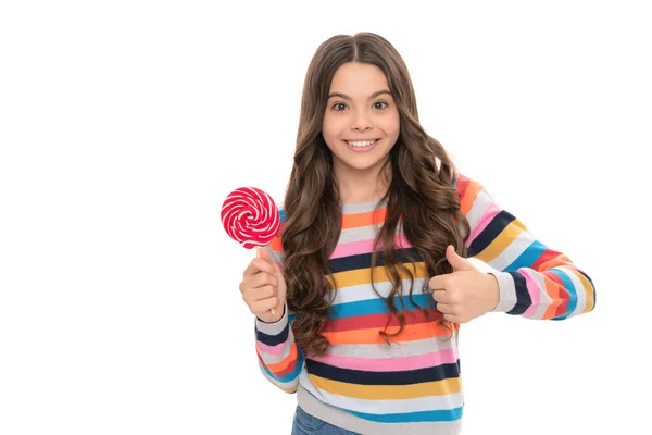 Kind in kleurrijke trui houden lollypop. Snoep op stokje. Karamel snoepwinkel. kindertijd. — Stockfoto