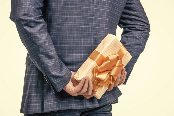 it is mine. corporate present. womens day. successful ceo hiding giftbox. cropped man prepare for romance date. man with business reward. occasion greeting. surprise. businessman holding gift box.