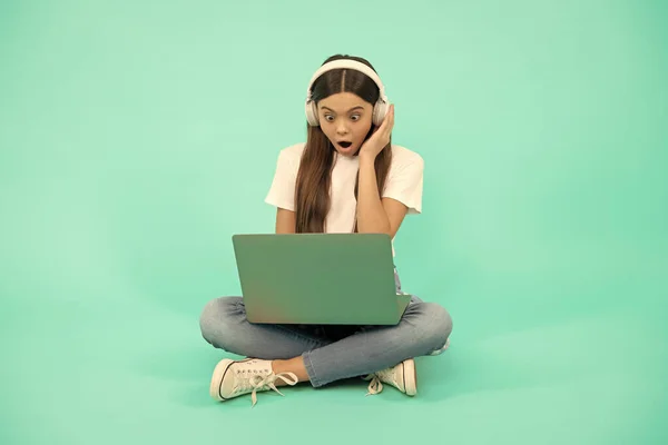 surprised kid chat on computer. buy online. back to school. teen influencer blogging. girl in headphones. music. webinar in wireless headset. modern education. communication technology. video call.