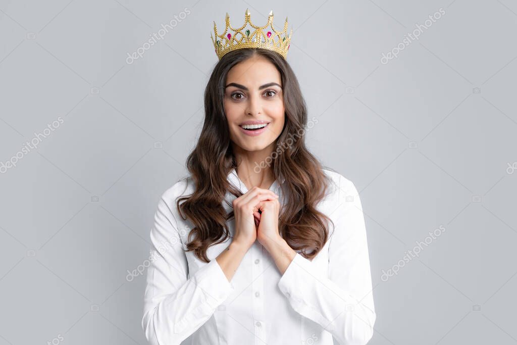 Portrait of woman queen. Gorgeous girl with crown. Party celebration concept. Close-up portrait of charming smiling lovely girl holding queen crown, gray background