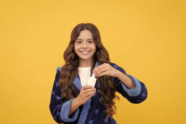 i use this. against allergy. best remedy against runny nose. free your stuffy nose. covid 19. happy teen girl use nasal drops. kid presenting useful nasal spray. smiling child in pajama.