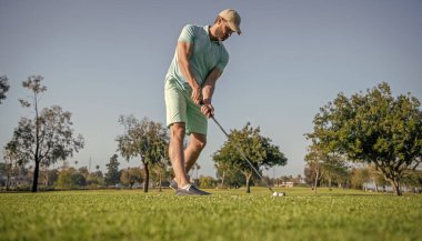professional sport outdoor. male golf player on professional golf course. portrait of golfer in cap with golf club. people lifestyle. bearded man playing game on green grass. summer activity.